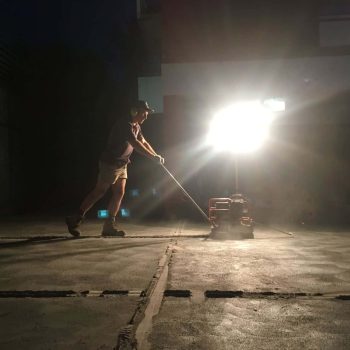 Complete Concreters Mornington cutting expansions joints in a new concrete driveway at night in Flinders